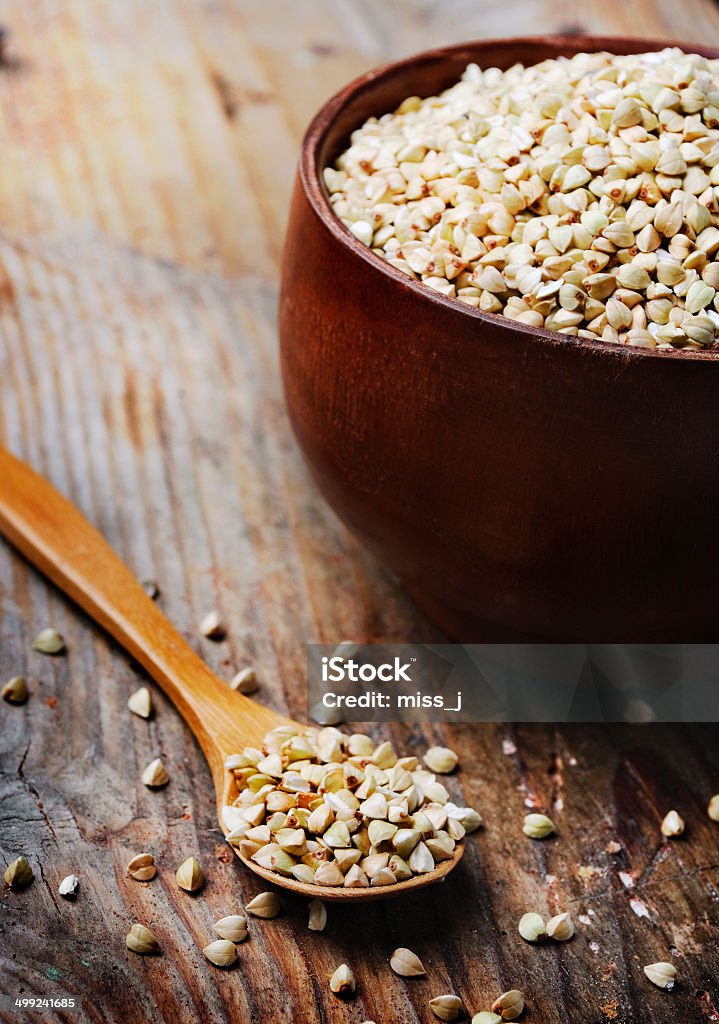 Buckwheat Buckwheat in bowl on wooden background Agriculture Stock Photo