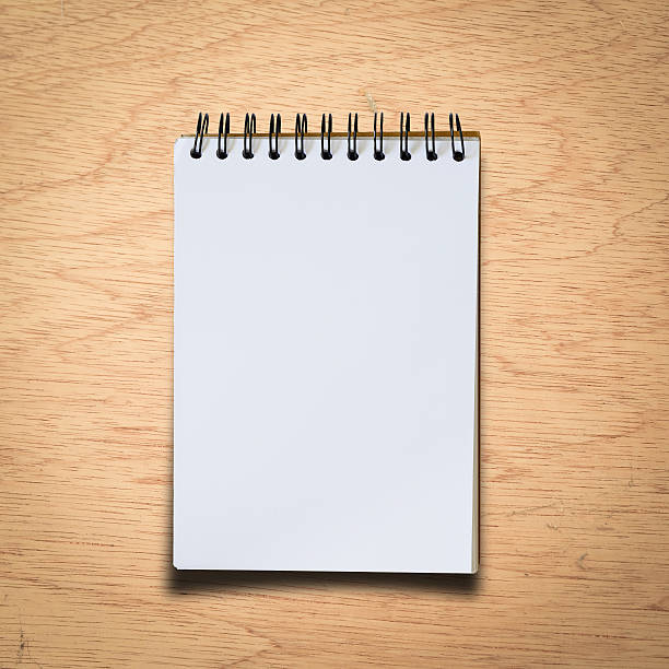 istock Black notebook on a wood background with clipping path 499242741