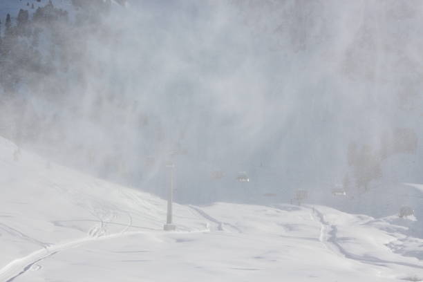 istock Snowing artificial snow made with snowgun during beautiful day 499243311