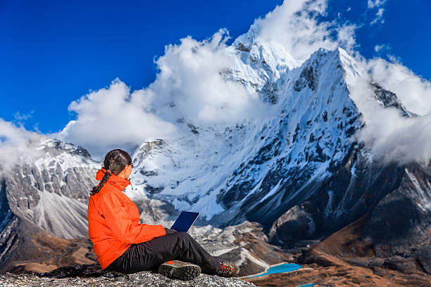istock Woman is using laptop in Mount Everest National Park, Nepal 499244221