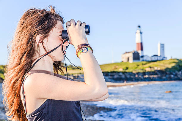 istock Teenage girl exploring ocean with binocular 499245163