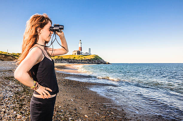 istock Teenage girl exploring ocean with binocular 499245201