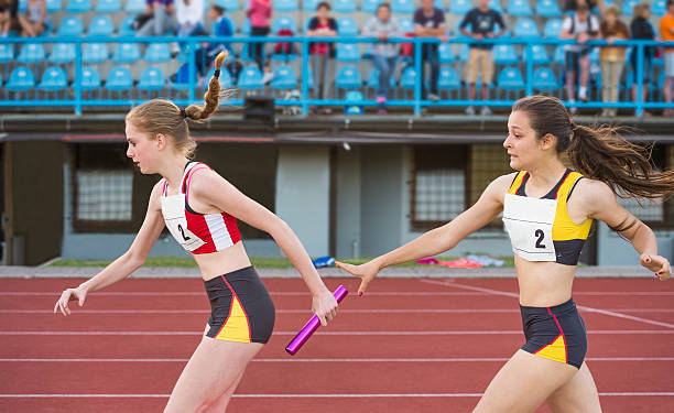 istock Side View of Beautiful Two Athletes at Relay Passing 499245895