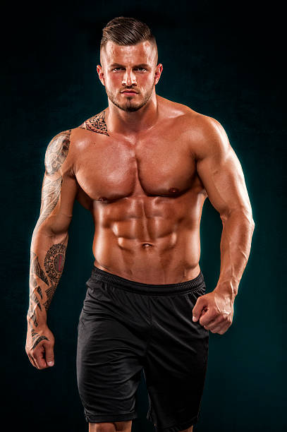 Handsome Muscular Men Handsome Muscular Men Walking Towards You. Studio Shot chest tattoo men stock pictures, royalty-free photos & images