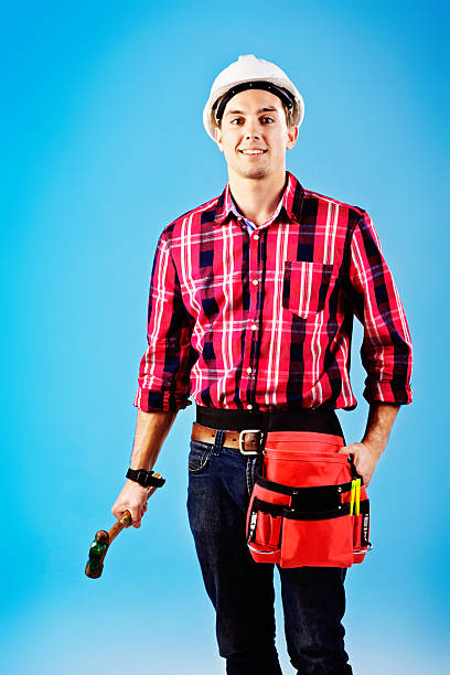 istock Handsome handyman with hardhat and tool belt smiles 499246867