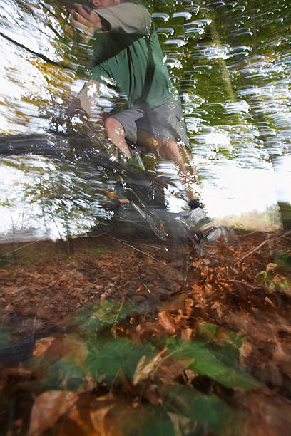 istock Man Riding Bike Through Forest 499247495