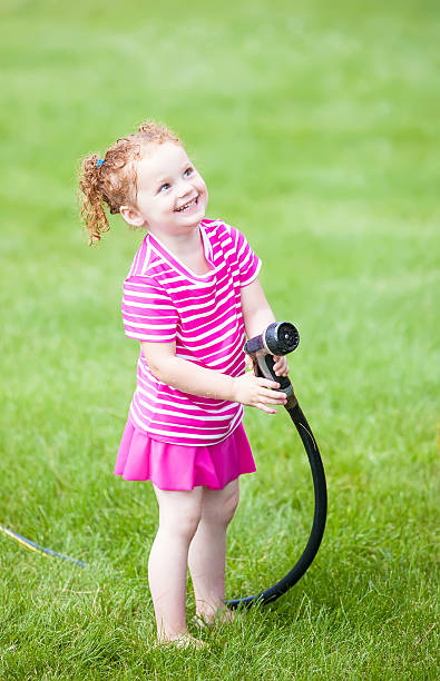 istock Happy Girl With Garden Hose 499247923