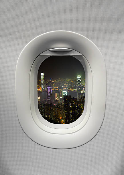 istock night time hong kong at Airplane window 499247967
