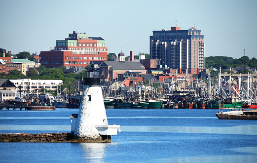 New Bedford Harbor and downtown skyline.  New Bedford is America's #1 fishing port with a large fishing fleet. Also known as the  The Whaling City because during the 19th century, the city was one of the most important whaling ports in the world.