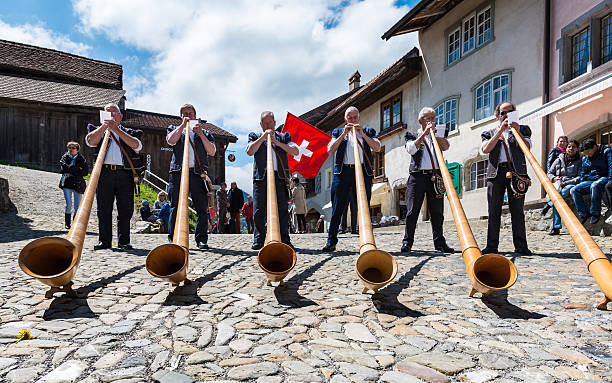 Swiss musicians on the cheese festival in Gruyere, Switzerland. Gruyere, Switzerland - May 4, 2014. Swiss musicians on the cheese festival. alpenhorn stock pictures, royalty-free photos & images