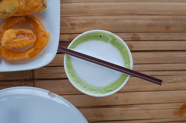 istock Hot Green Tea Latte on bamboo table 499255066
