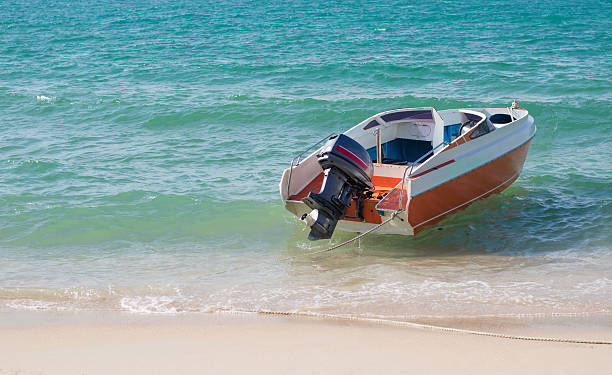 istock speed boat on beach waiting for traveller 499256112