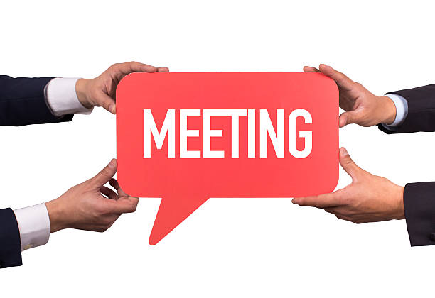 istock Two men holding red speech bubble with MEETING message 499257252