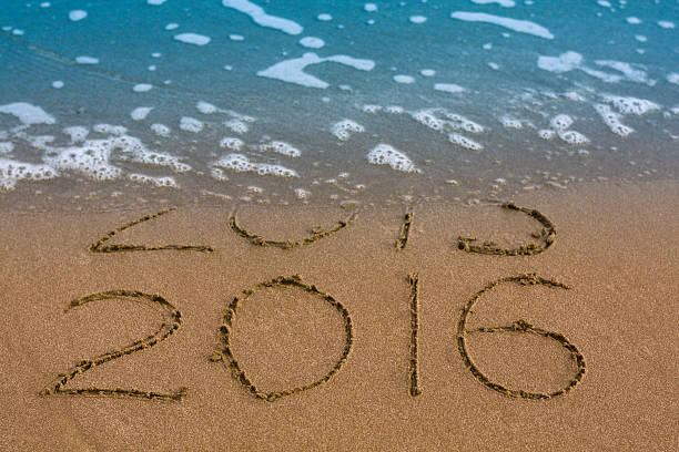 istock Happy New Year 2016 replace 2015 concept on sea beach 499257264