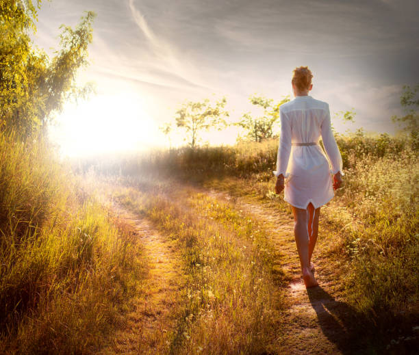 Beautiful woman walking on the field