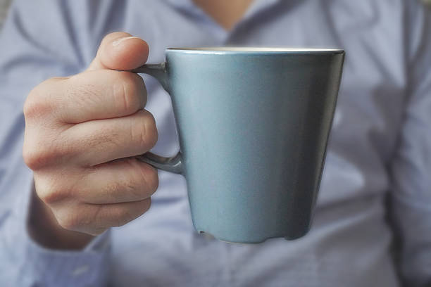 istock Close-up of male hand holding mug 499258012