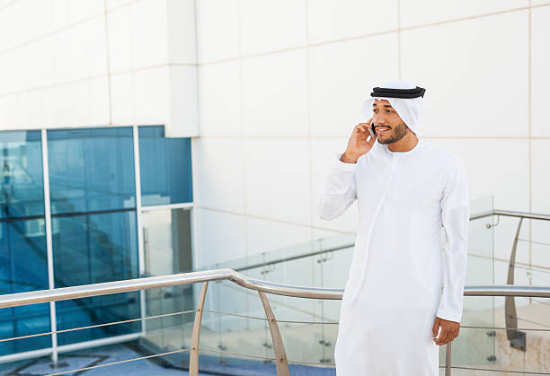istock Arab Businessman Talking Over Mobile Phone Outside Office 499258596