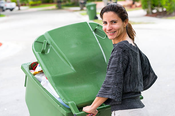 istock Hispanic Housewife pushing the trash can 499258789