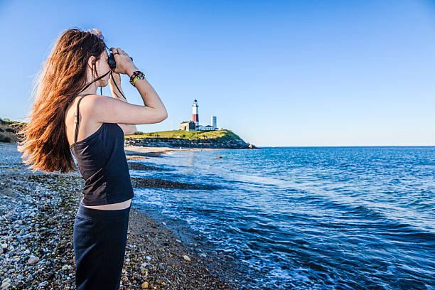 istock Teenage girl exploring ocean with binocular 499258887