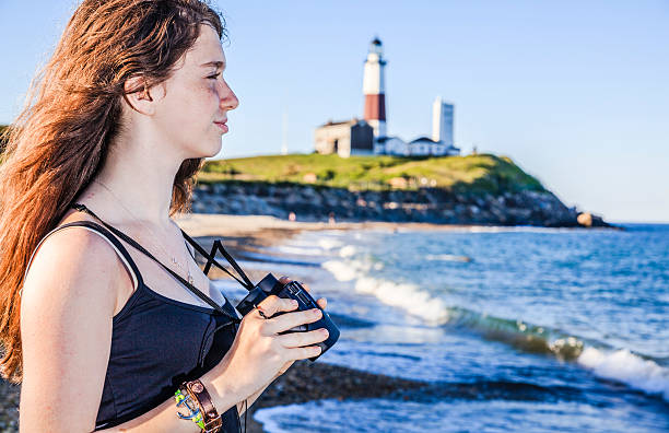 istock Teenage girl exploring ocean with binocular 499258889