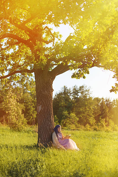 istock Woman reading book in the park 499259829
