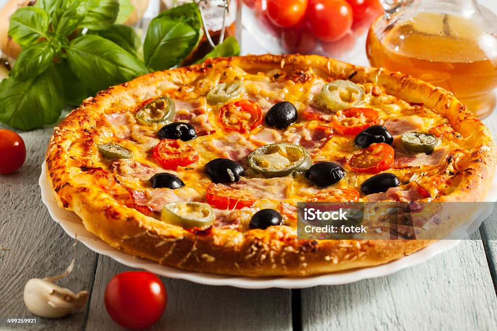 Pizza con tocino, aceitunas y jalapeño - Foto de stock de Abofetear libre de derechos