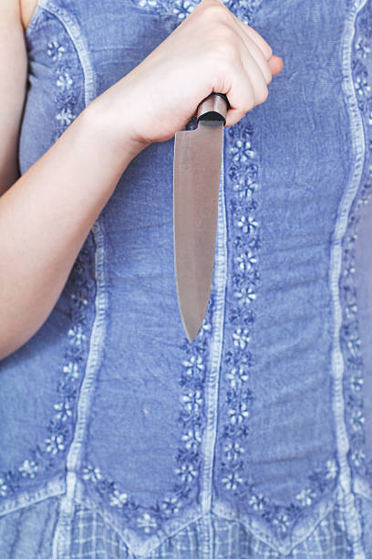 istock girl holding large kitchen knife 499263595
