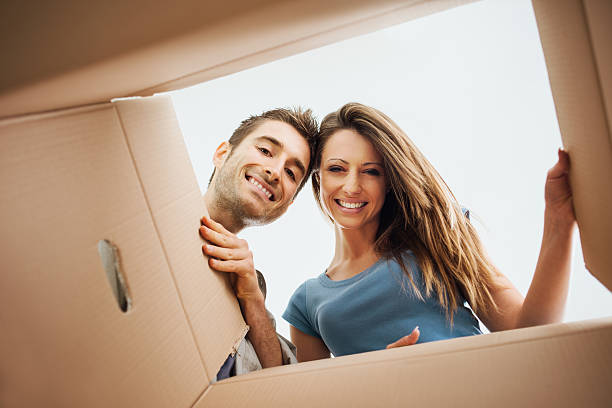 Happy couple opening a box