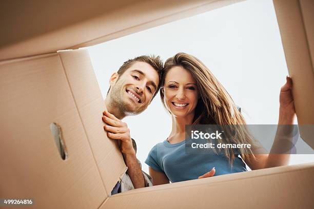 Happy Couple Opening A Box Stock Photo - Download Image Now - Box - Container, Opening, Inside Of