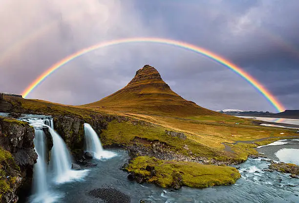 Photo of Kirkjufell Mountain and Kirkjufellsfoss Waterfalls Against the Rainbow,  Autumn.