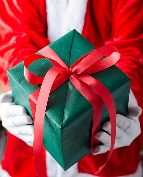 istock Santa Claus Showing a Christmas Gift Box 499266626