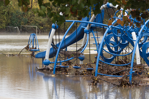 After two days and nights of heavy November rains, Little Bear Creek overflowed its banks and flooded Sparger Park pushing leaves, branches and debris over the playground equipment and soccer nets in the suburb of Colleyville, Dallas Texas.