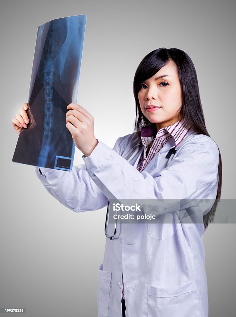 Female doctor examing an x-ray Adult Stock Photo