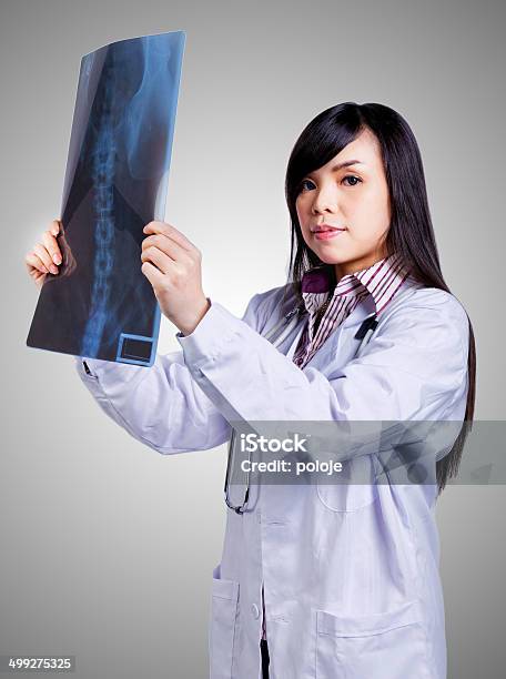 Female Doctor Examing An Xray Stock Photo - Download Image Now - Adult, Adults Only, Analyzing