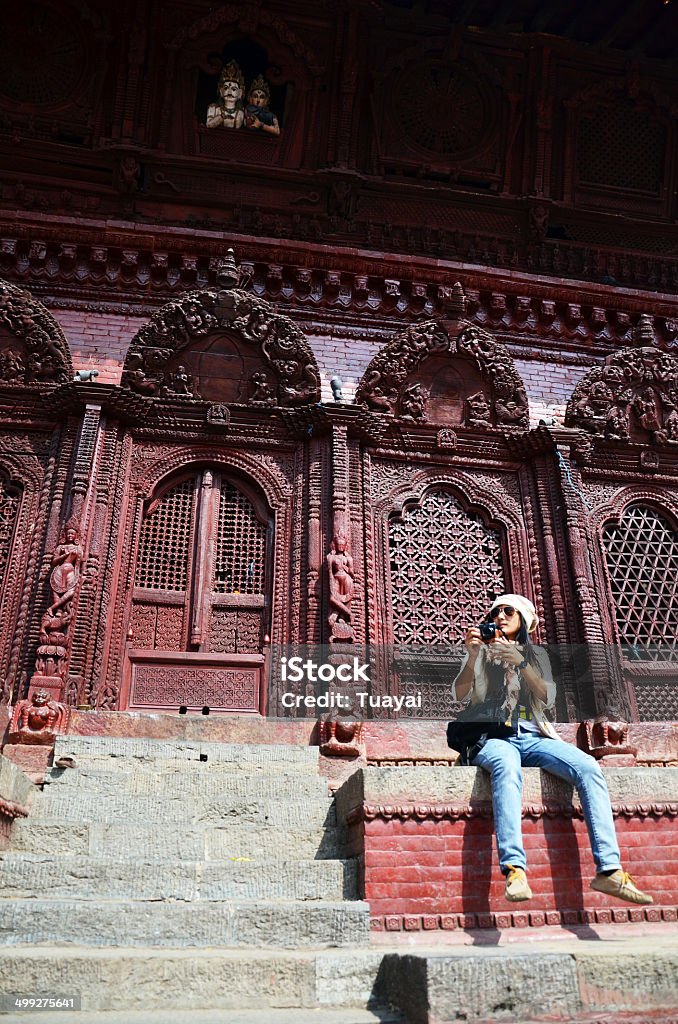 Traveler at Durbar square at Kathmandu Nepal Durbar Square is the generic name used to describe plazas and areas opposite the old royal palaces in Nepal. It consists of temples, idols, open courts, water fountains and more. Before the Unification of Nepal, Nepal consisted of small kingdoms, and Durbar Squares are most prominent remnants of those old kingdoms in Nepal. In particular, three Durbar Squares in the Kathmandu Valley, belonging to the three Newar kingdoms situated there before unification, are most famous: Kathmandu Durbar Square, Patan Durbar Square, and Bhaktapur Durbar Square. All three are UNESCO World Heritage Sites. Adult Stock Photo