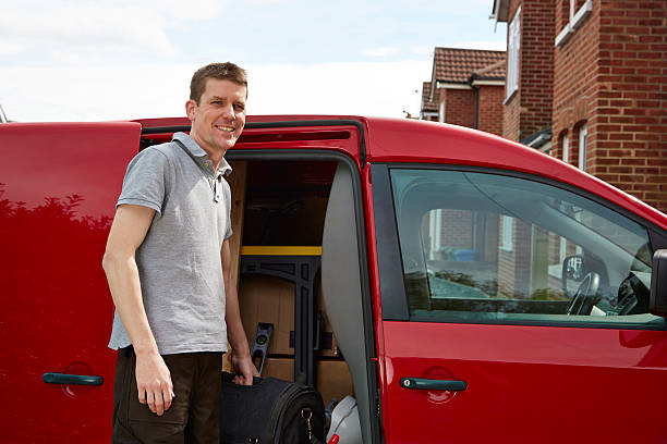 istock Tradesman standing by van holding toolbag 499278531