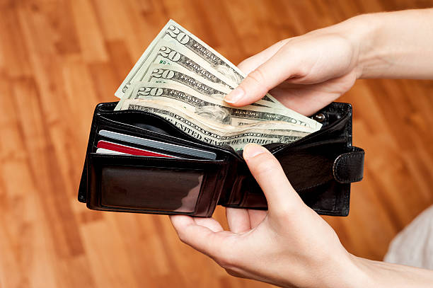 istock Human hand takes money bills from wallet close up 499280767