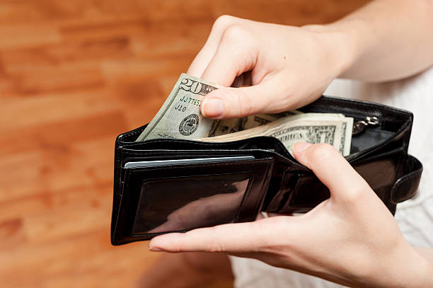 istock Human hand takes money bills from wallet close-up 499280807