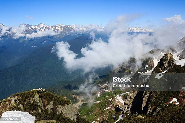 Clouds Above Caucasus Mountain Peaks Covered With Snow And Forest Stock Photo - Download Image Now