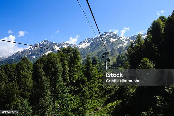 Ropeway Cabins In Caucasus Mountains Covered With Forest And Snow Stock Photo - Download Image Now