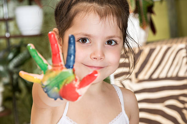 istock Girl shows palm smeared in paint 499284384