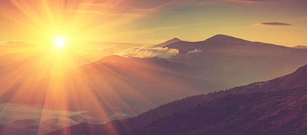 Panoramic view of mountains in sunrise. stock photo