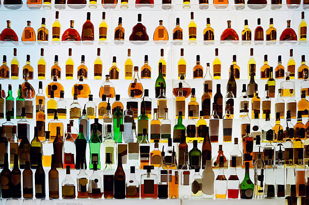 Various alcohol bottles in a bar Various alcohol bottles in a bar, back light, all logos removed vodka photos stock pictures, royalty-free photos & images