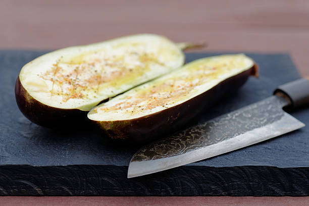 istock Eggplant prepared for grilling and old knife 499286944