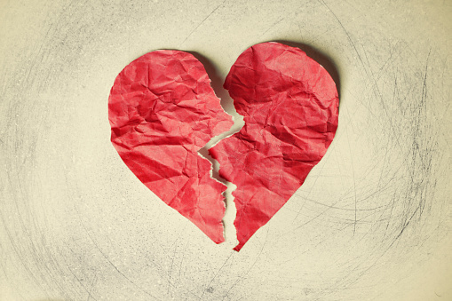 Heart form in red on a crumpled paper background