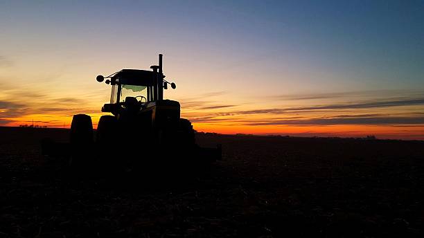 Tractor Silhouette at Sunset on an Iowa Farm