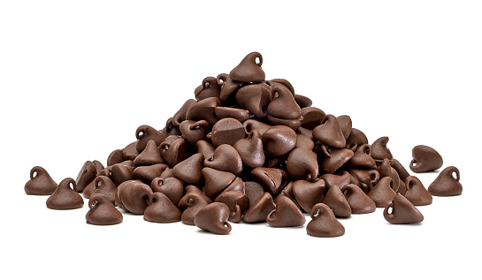 Chocolate morsels pile on white background