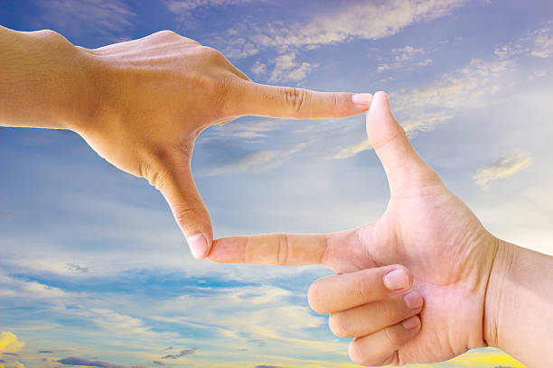 istock Photo sight:Frame made of hands with sunset sky 499291870