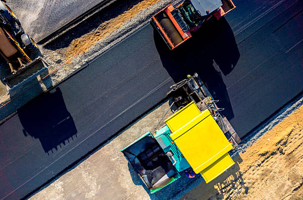 New road construction Aerial view on the new asphalt road under construction asphalt stock pictures, royalty-free photos & images