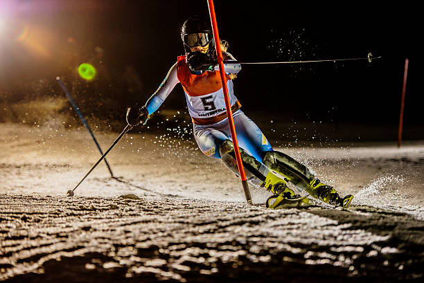 istock Professional female alpine skiier practicing in the night 499293476